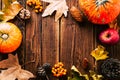 Autumn background. Frame made of dry leaves, pumpkin and cones. Copspace