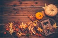 Rustic autumn still life with pumpkins and golden leaves on a wooden surface Royalty Free Stock Photo