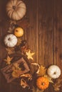 Rustic autumn still life with pumpkins and golden leaves on a wooden surface Royalty Free Stock Photo