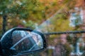 Autumn background, rain drops on the car side view window Royalty Free Stock Photo