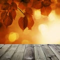 Autumn Background with Red Linden Leaves and Abstract Bokeh Glitter with empty dark wooden board background Royalty Free Stock Photo