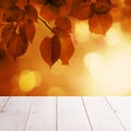Autumn Background with Red Linden Leaves and Abstract Bokeh Glitter with empty white wooden board background Royalty Free Stock Photo