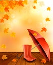 Autumn background with umbrella and rain boots.
