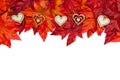 Autumn background with wood hearts and red and orange fall leave
