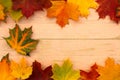 Autumn background. On a wooden board lie yellow leaves at the edges.