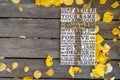 Autumn background. Wooden carved word of the Lord`s Prayer on a shabby wooden board with yellow leaves Royalty Free Stock Photo