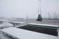 Autumn bad weather, snow, loading coal into the holds of industrial ships in the seaport Royalty Free Stock Photo