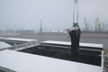 Autumn bad weather, snow, loading coal into the holds of industrial ships in the seaport Royalty Free Stock Photo