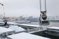 Autumn bad weather, snow, loading coal into the holds of industrial ships in the seaport Royalty Free Stock Photo