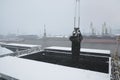 Autumn bad weather, snow, loading coal into the holds of industrial ships in the seaport Royalty Free Stock Photo