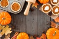 Autumn baking frame with pumpkin pie tarts over wood