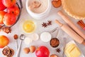 Autumn baking table scene with apple pie ingredients over a white marble