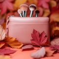 Autumn beauty essentials Pink leather clutch, makeup brushes, and leaves