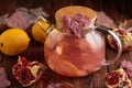 Autumn Beverage: Pomegranate Tea with Lemon and Ginger on Rustic Table Royalty Free Stock Photo