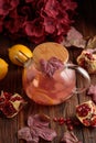 Autumn Beverage: Pomegranate Tea with Lemon and Ginger on Rustic Table Royalty Free Stock Photo
