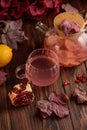 Autumn Beverage: Pomegranate Tea with Lemon and Ginger on Rustic Table Royalty Free Stock Photo