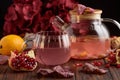 Autumn Beverage: Pomegranate Tea with Lemon and Ginger on Rustic Table Royalty Free Stock Photo