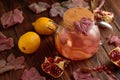 Autumn Beverage: Pomegranate Tea with Lemon and Ginger on Rustic Table Royalty Free Stock Photo