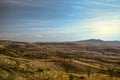 Autumn blue sky over a hilly valley with villages and fields in the mountains Geghama ridge Royalty Free Stock Photo