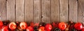 Autumn border of apples, leaves, and fall decor over a rustic wood background Royalty Free Stock Photo