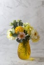 Autumn bouquet with fresh dahlia flowers in yellow glass vase Royalty Free Stock Photo