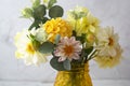 Autumn bouquet with fresh dahlia flowers in yellow glass vase Royalty Free Stock Photo