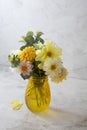 Autumn bouquet with fresh dahlia flowers in yellow glass vase Royalty Free Stock Photo