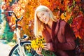 Autumn bouquet. Warm autumn. Girl with bicycle and flowers. Woman bicycle autumn garden. Active leisure and lifestyle Royalty Free Stock Photo