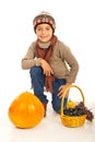 Autumn boy with pumpkin and grapes Royalty Free Stock Photo