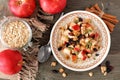 Autumn breakfast oatmeal, overhead scene on rustic wood