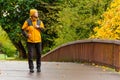 Autumn, bridge and a man in a yellow jacket.