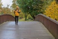 Autumn, bridge and a man in a yellow jacket.