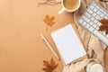 Autumn business concept. Top view photo of paper sheet envelope pen keyboard cup of coffee candle fallen maple leaves and plaid on Royalty Free Stock Photo