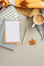Autumn business concept. Top view vertical photo of envelope and paper sheet over planner pen yellow maple leaves keyboard cup of Royalty Free Stock Photo