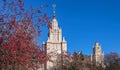 Autumn campus of famous Russian university with small red apple trees under blue sky