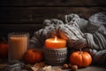 Autumn candles, small pumpkins on background of gray woolen plaid. Generative AI