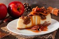 Autumn caramel apple pecan cheesecake, close up side against wood