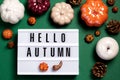 Autumn Card With Hello Autumn Text, Pumpkins, Pine Cones And Autumn Decor On Dark Green Background