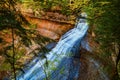 Autumn Waterfall in Forest with Sunlit Leaves - Chapel Falls, Michigan Royalty Free Stock Photo