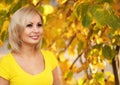 Autumn Cheerful Woman. Blonde Girl and Yellow Leaves