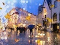 Autumn city blur ,man with blue umbrella,Rainy  city  evening people walking under umbrella evening Autumn leaves fall street in m Royalty Free Stock Photo