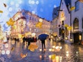 Autumn city blur ,man with blue umbrella,Rainy city evening people walking under umbrella evening Autumn leaves fall street in m Royalty Free Stock Photo