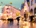 Autumn city blur ,man with blue umbrella,Rainy city evening people walking under umbrella evening Autumn leaves fall street in m Royalty Free Stock Photo