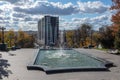 Autumn city fountain and residential building