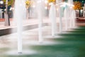 Autumn city park at night, fountains, trees with yellow leaves and street lights Royalty Free Stock Photo