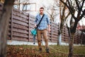 Autumn cleaning. Worker using garden vacuum and leaf blower Royalty Free Stock Photo