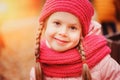 Autumn close up portrait of happy little child girl enjoying the walk in sunny park