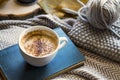 Autumn coffee cup with book and knitting wool and needles, cozy fall deco concept, home lifestyle warm coffee cup in autumn