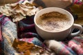 Autumn coffee cup with cozy blanket and dried leaves, fall deco warm home weekend with coffee cup, autumn concept