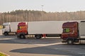 Trucks parked in a roadside parking lot. Autumn cold morning